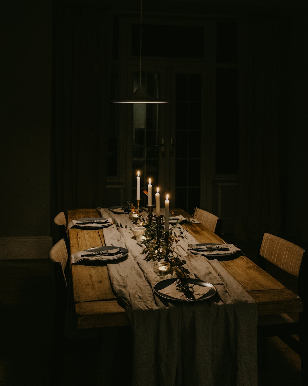 A long table set and lit by candles